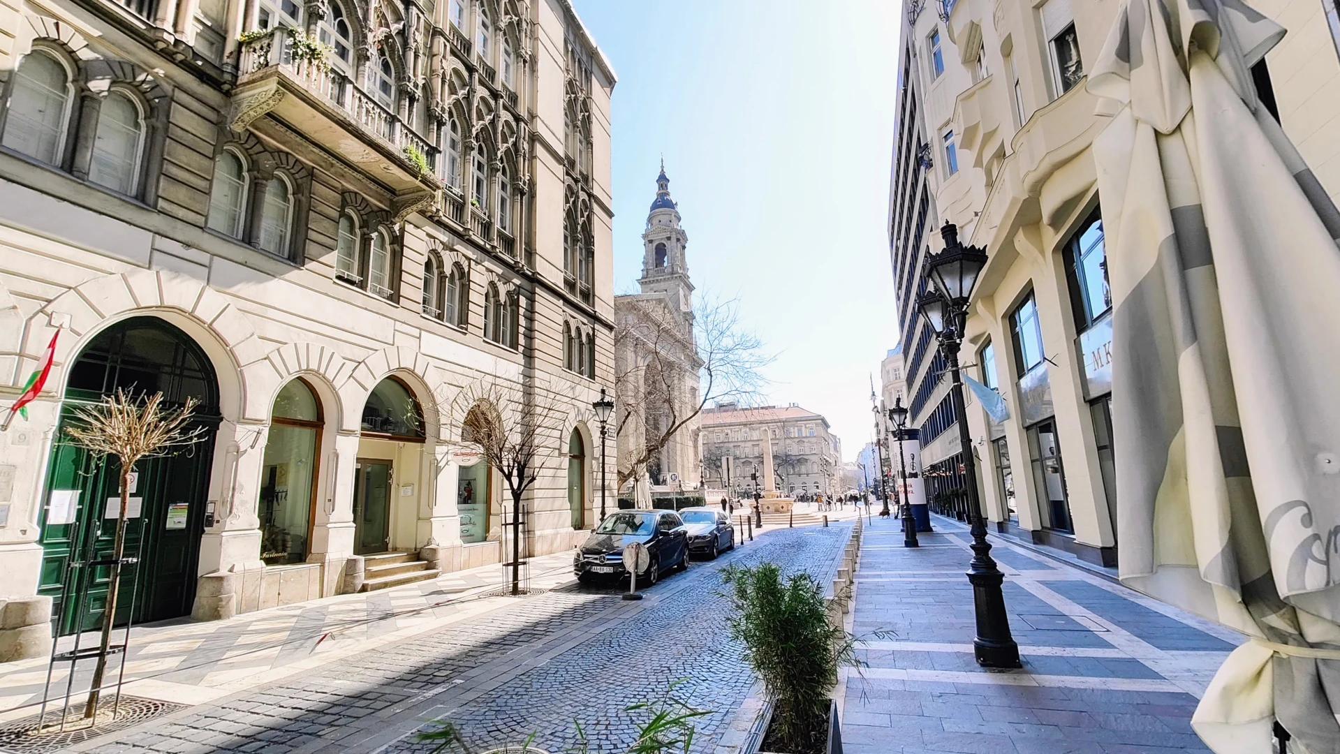 A grand street, with dressed stone buildings to each side. A cobbled road - clean and gleaming in the sunshine, the dark stone contrasting with the bleached buildings in the early spring sunshine. A cathedral can be seen just down the road, enticing the viewer to walk just a little further.